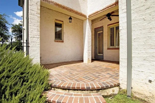 a view of house with swimming pool outdoor seating and house in the background