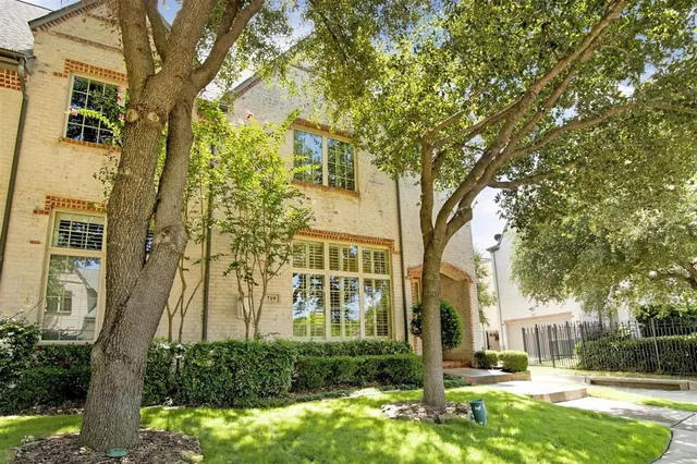 a front view of a residential apartment building with a yard