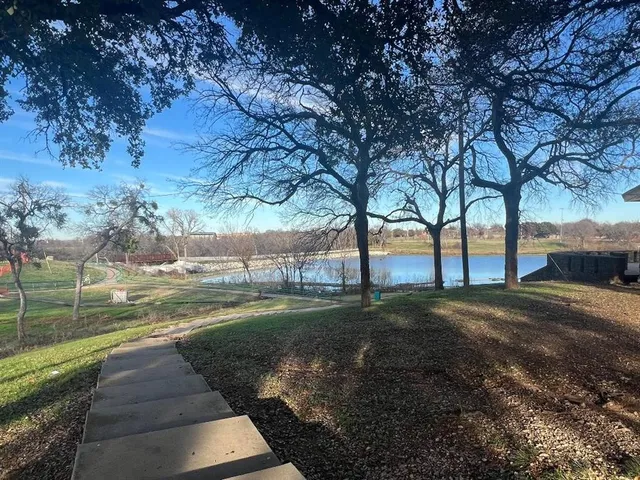 a view of road with large trees