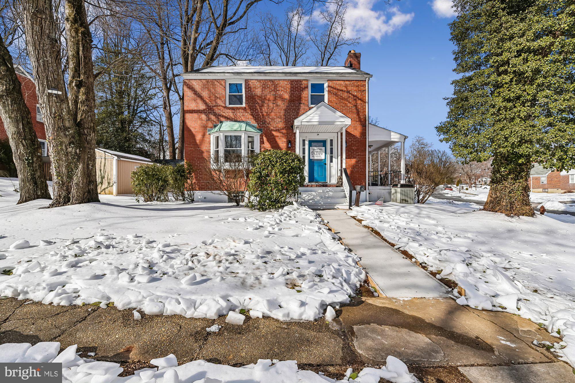 a view of a house with snow on the road