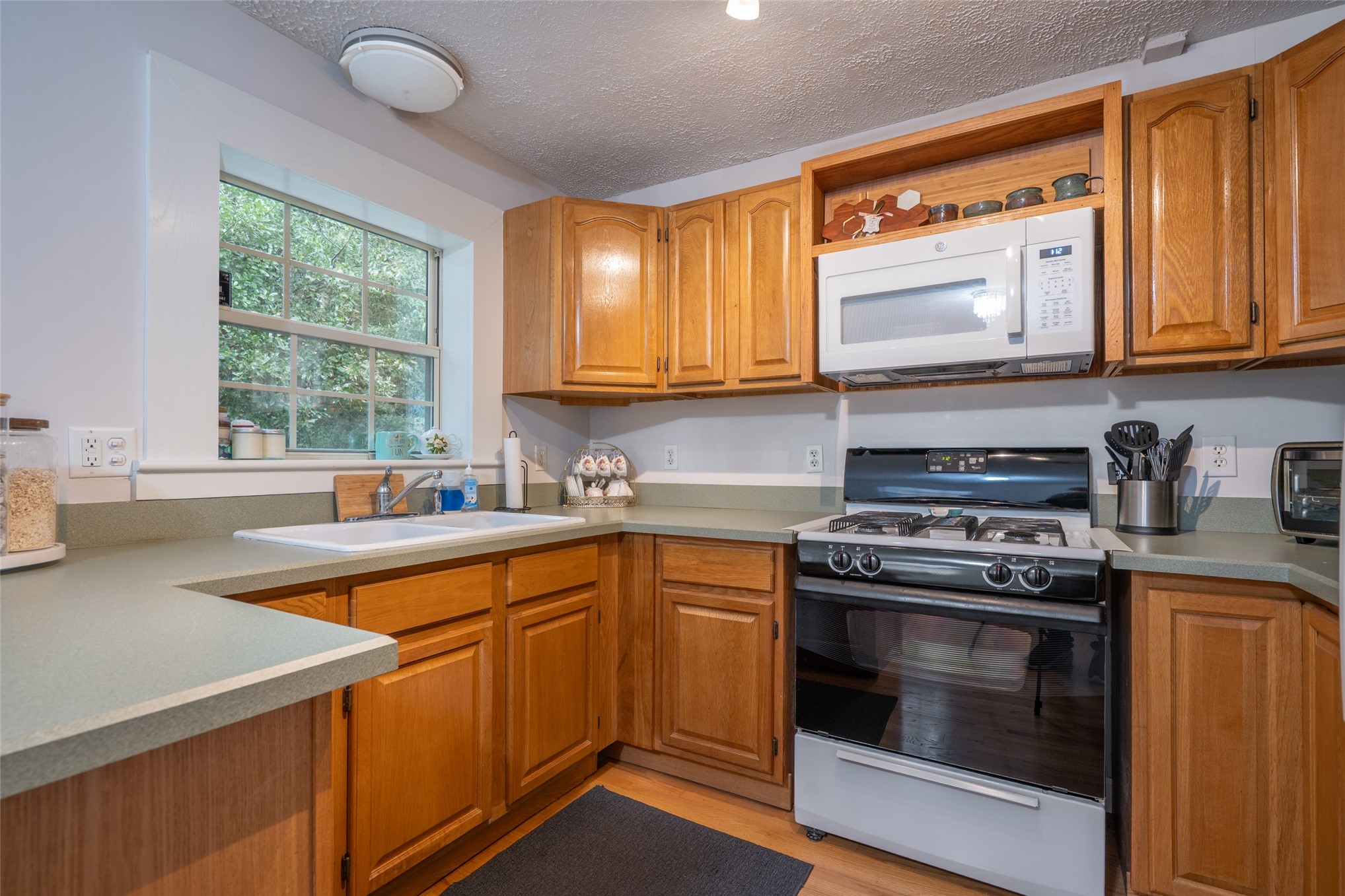 807 Stanley Drive Fernandina Beach, FL 32034 - Photo 13 of 30 a kitchen with stainless steel appliances granite countertop a stove a sink and a microwave