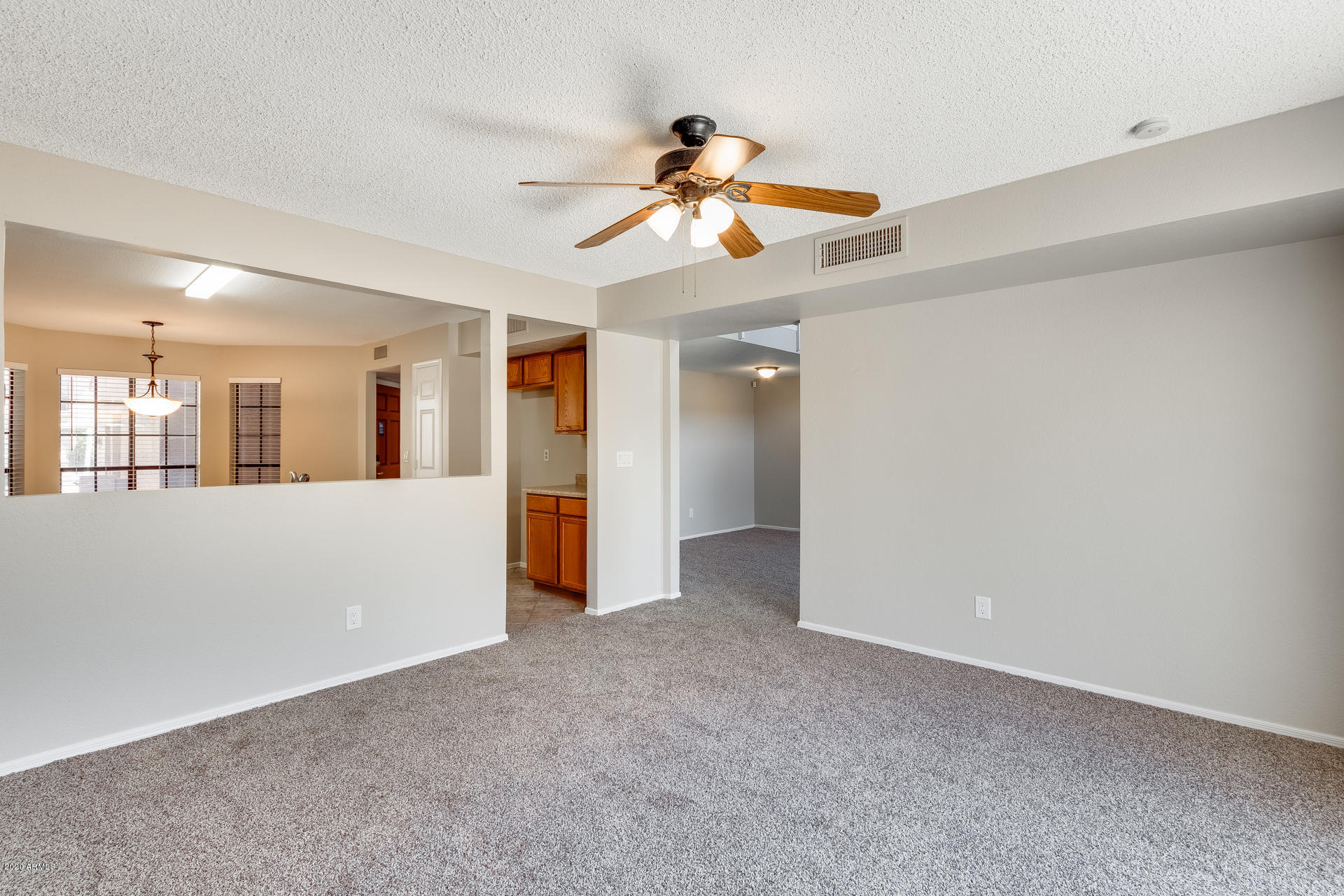 4157 East Agave Road Phoenix, AZ 85044 - Photo 15 of 33 a view of an empty room with window and a kitchen