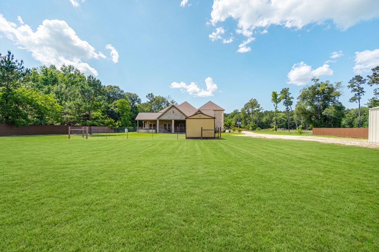 21038 Angus Drive Cleveland, TX 77328 - Photo 46 of 49 a view of a house with a big yard and chandelier