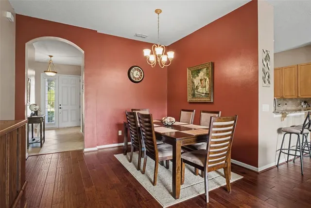 a view of a dining room with furniture wooden floor and chandelier