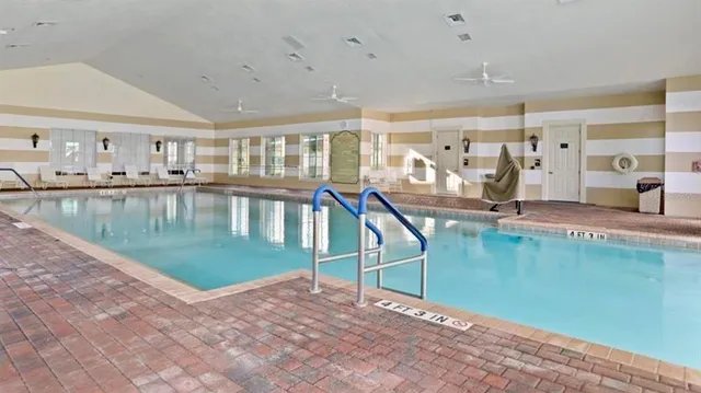 a living room with lots of furniture and chandelier