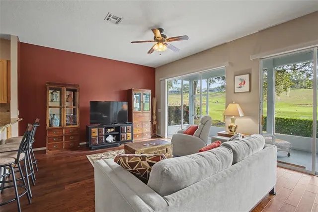 a living room with furniture a large window and a flat screen tv