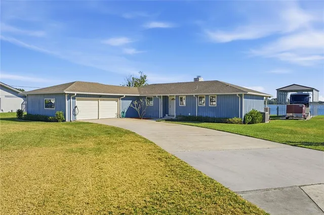 a view of a large building with a big yard and large trees