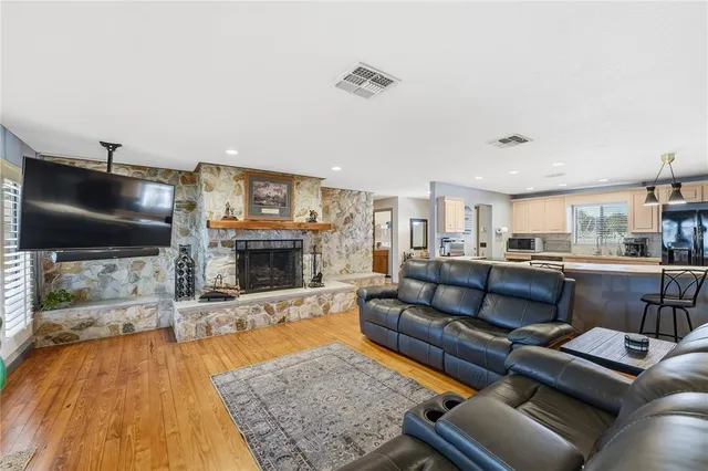a living room with furniture a flat screen tv and a fireplace
