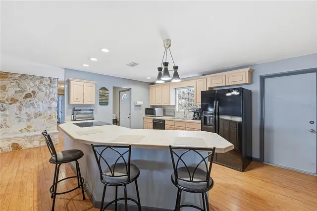a kitchen with a sink stove and refrigerator