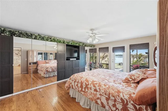 a bedroom with a large bed and a chandelier