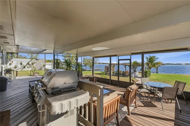 a view of a patio with a dining table and chairs with wooden floor