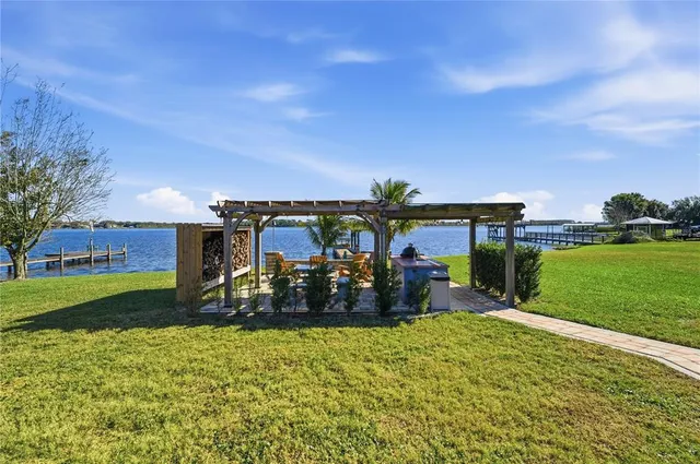 a view of a house with swimming pool and sitting area