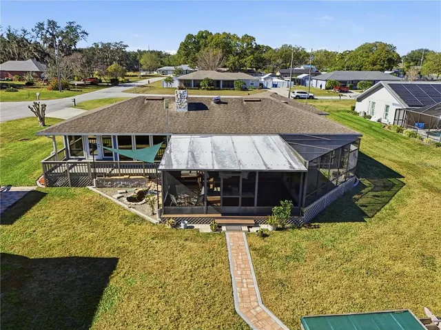 an aerial view of a house with swimming pool garden and lake view