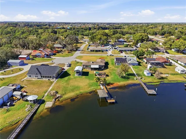a view of a swimming pool with lawn chairs under an umbrella