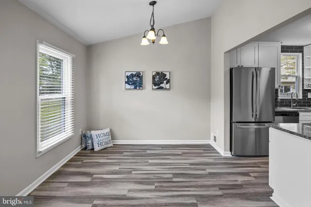 a view of a room with wooden floor and a window