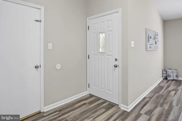 a view of a room with wooden floor