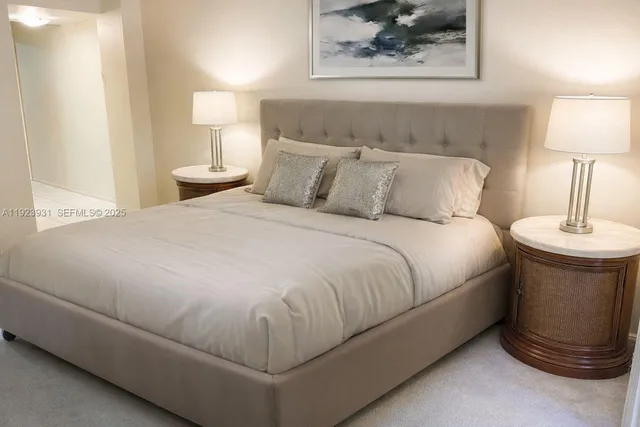 a bedroom with a bed and a lamp