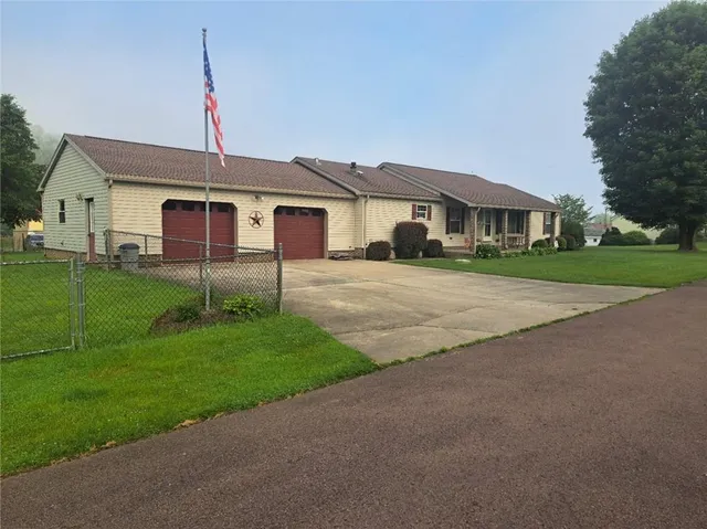 a front view of a house with a garden