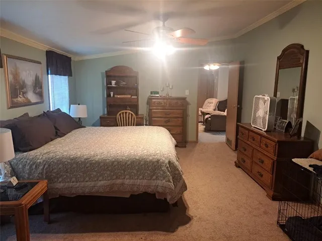 a bedroom with a bed a mirror on desk and chair