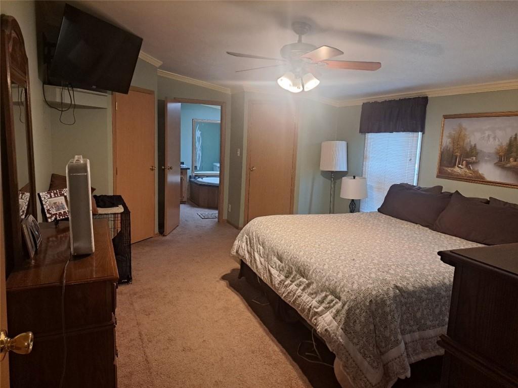 844 Williams Street Confluence, PA 15424 - Photo 9 of 13 a bedroom with a bed a dresser and potted plants with the wooden floor
