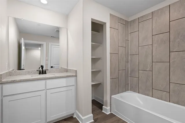 a bathroom with a granite countertop sink a toilet and shower