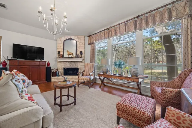 a kitchen with stainless steel appliances kitchen island granite countertop a refrigerator oven a sink dishwasher and white cabinets next to a window