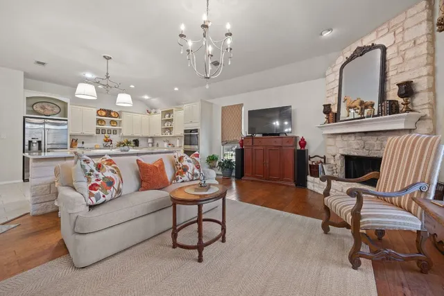 a view of a dining room with furniture and chandelier