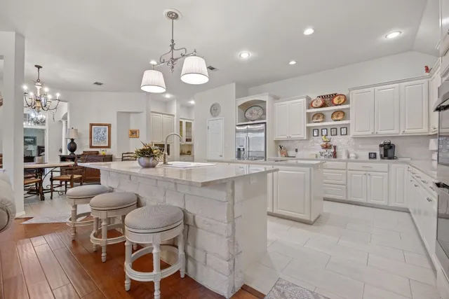 a en suite bathroom with a double vanity sink a mirror and a shower