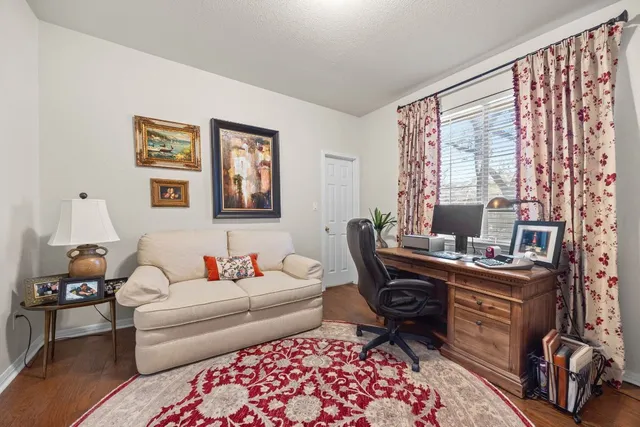 a living room with furniture a flat screen tv and a large window
