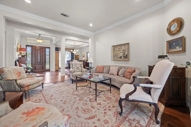 a living room with furniture a flat screen tv and a large window