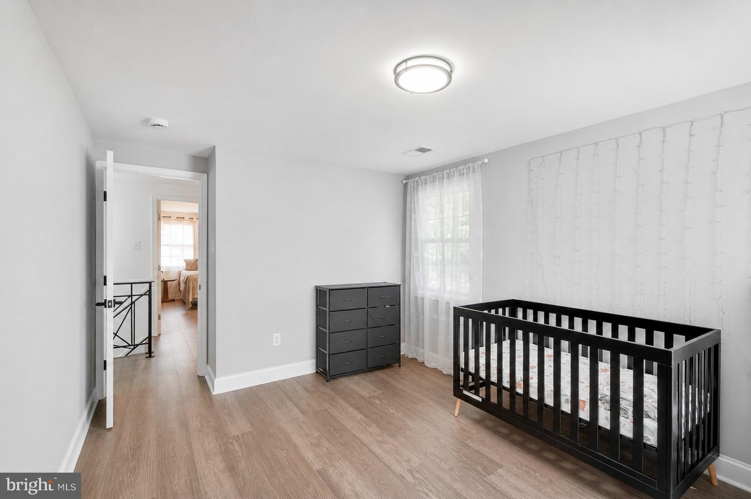 8812 Churchfield Lane Laurel, MD 20708 - Photo 23 of 31 a view of livingroom with hallway and wooden floor