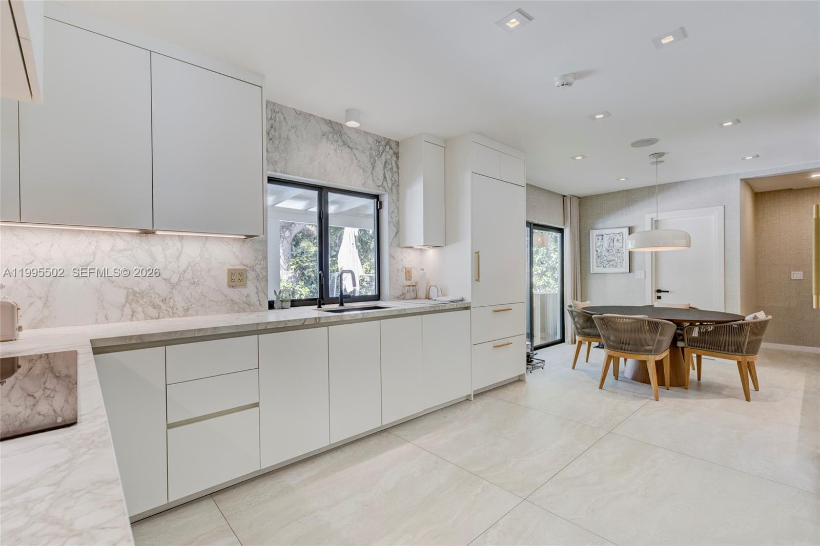 6449 Southwest 56th Street South Miami, FL 33155 - Photo 11 of 39 a kitchen with stainless steel appliances granite countertop a sink and a refrigerator
