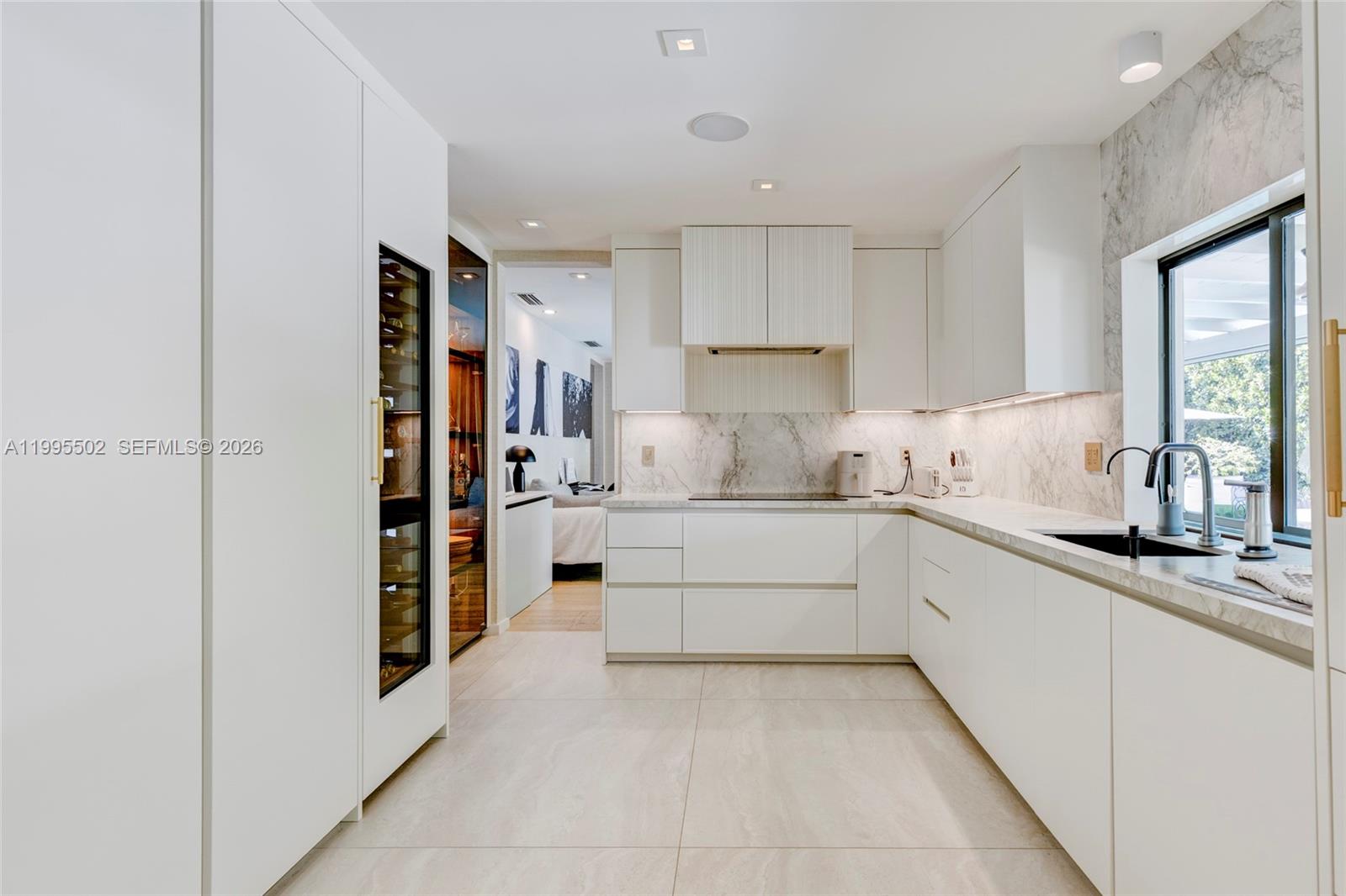 6449 Southwest 56th Street South Miami, FL 33155 - Photo 12 of 39 a kitchen with a refrigerator and a sink