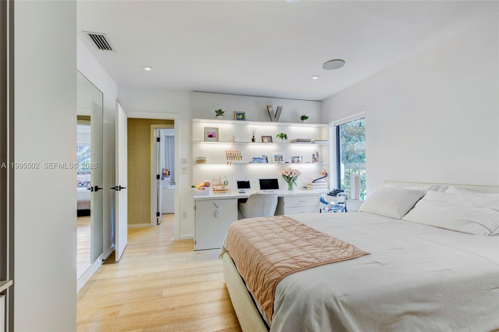 6449 Southwest 56th Street South Miami, FL 33155 - Photo 35 of 39 a bedroom with a large bed and a wooden floor