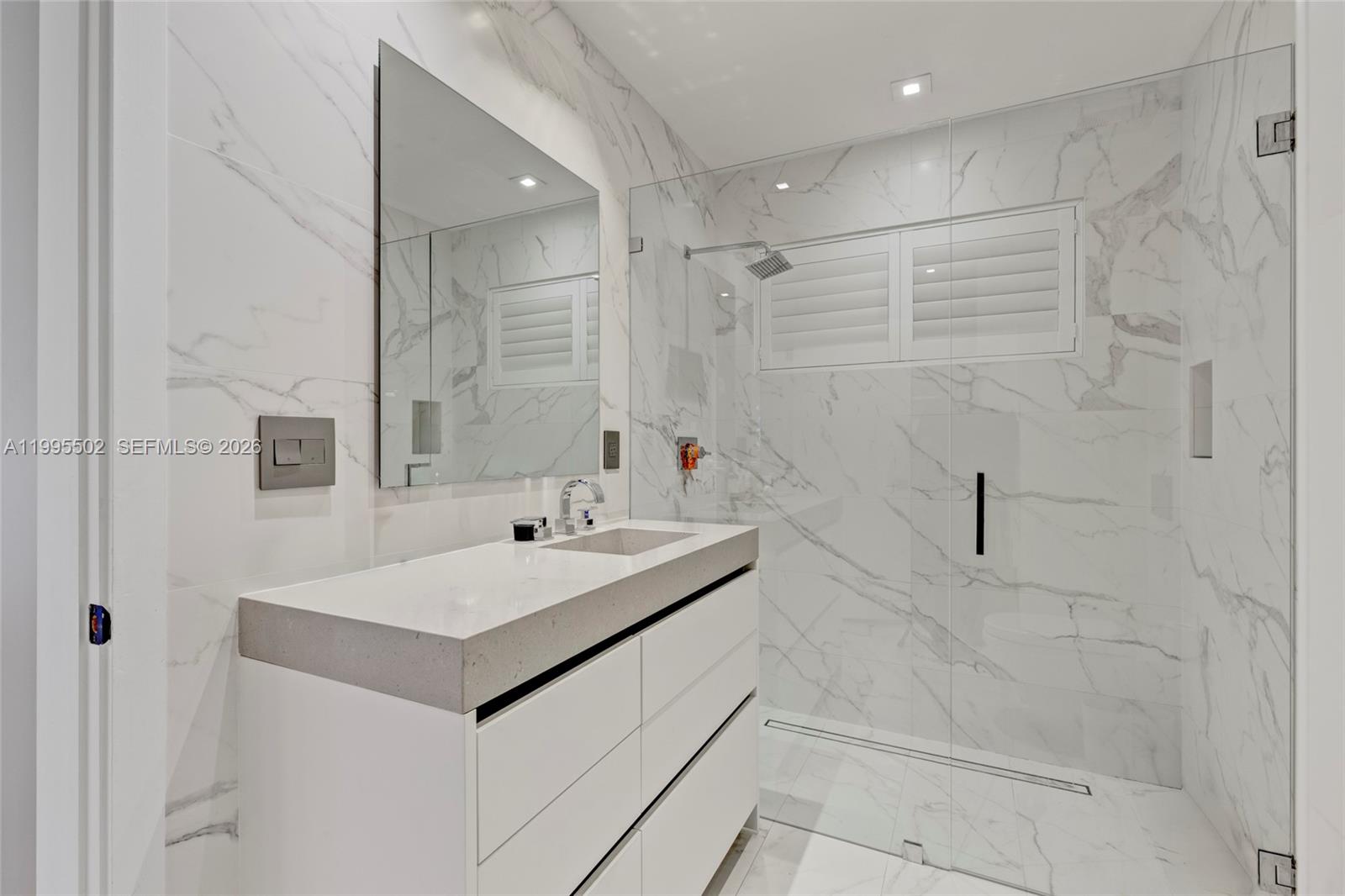 6449 Southwest 56th Street South Miami, FL 33155 - Photo 36 of 39 a bathroom with a sink shower and a mirror