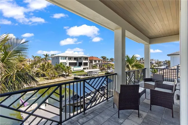 a balcony with chairs and table