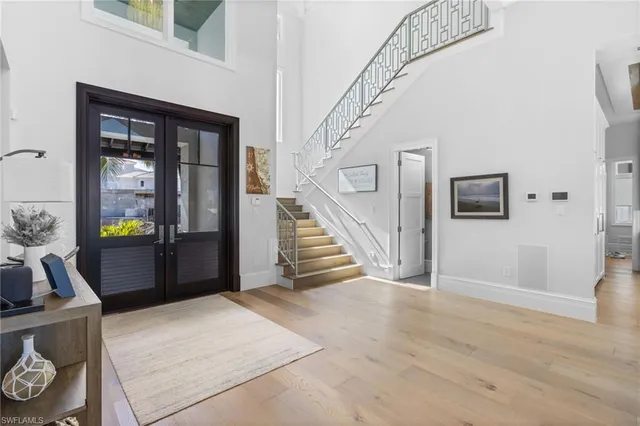 a view of a livingroom with wooden floor and stairs