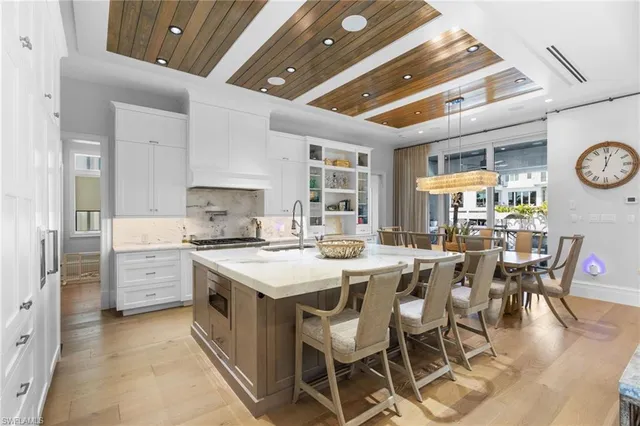 a large kitchen with a table and chairs