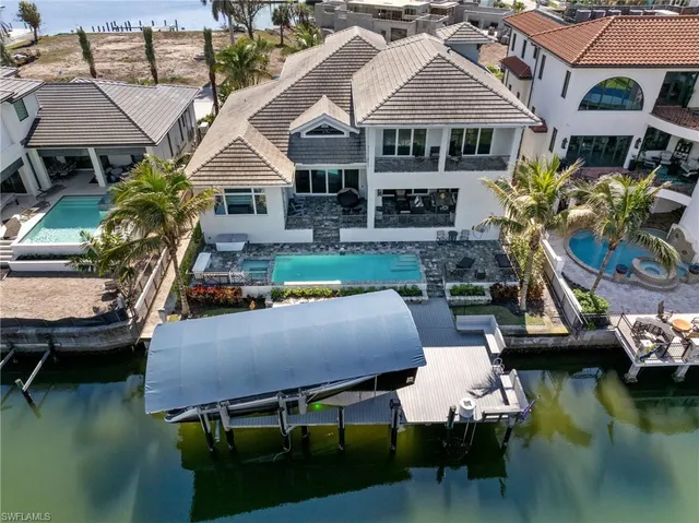 a aerial view of a house with swimming pool and a yard