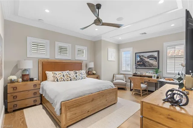 a bedroom with a bed a couch and a window