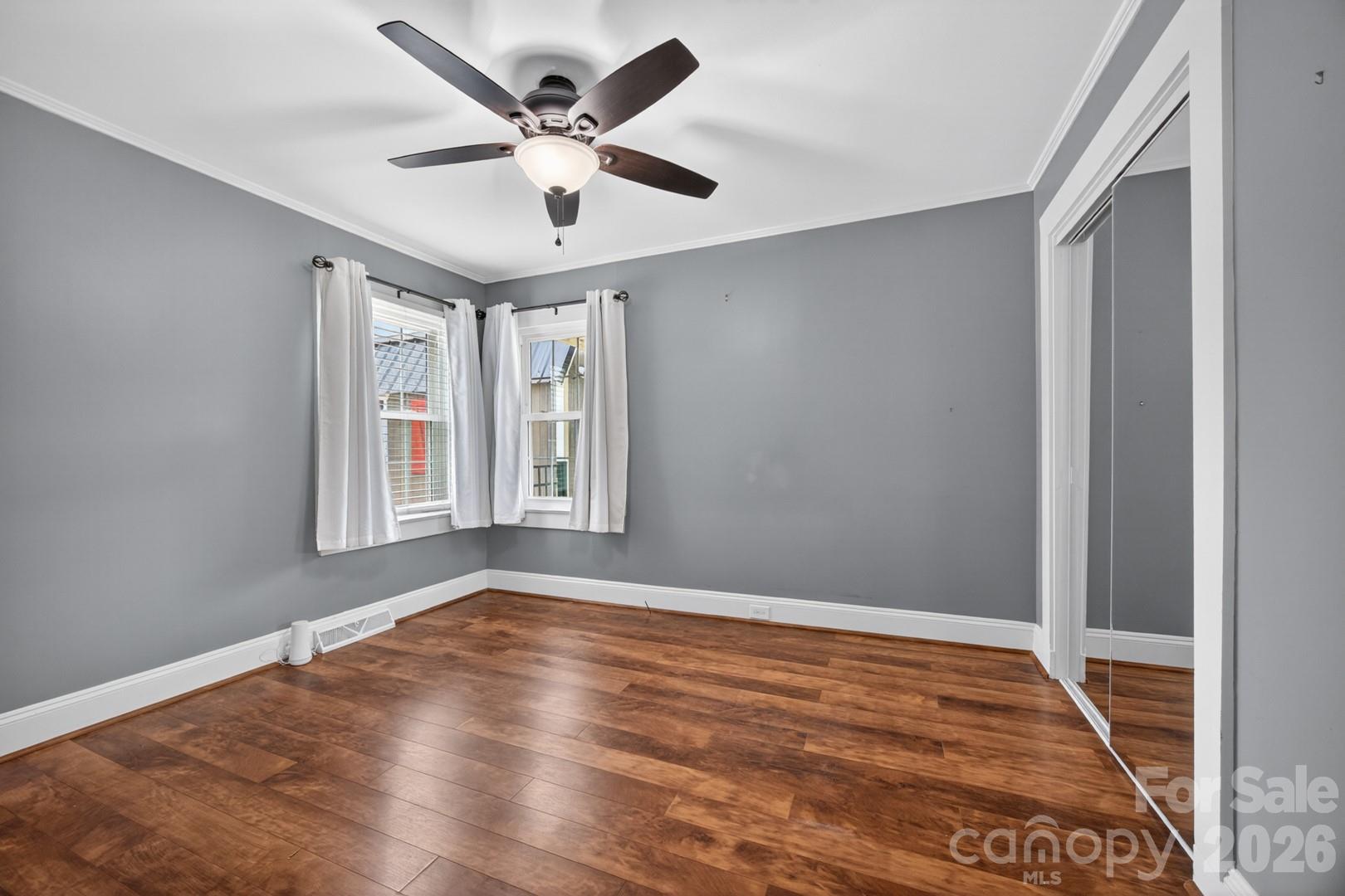 1016 Raney Street Salisbury, NC 28146 - Photo 16 of 45 an empty room with wooden floor and windows