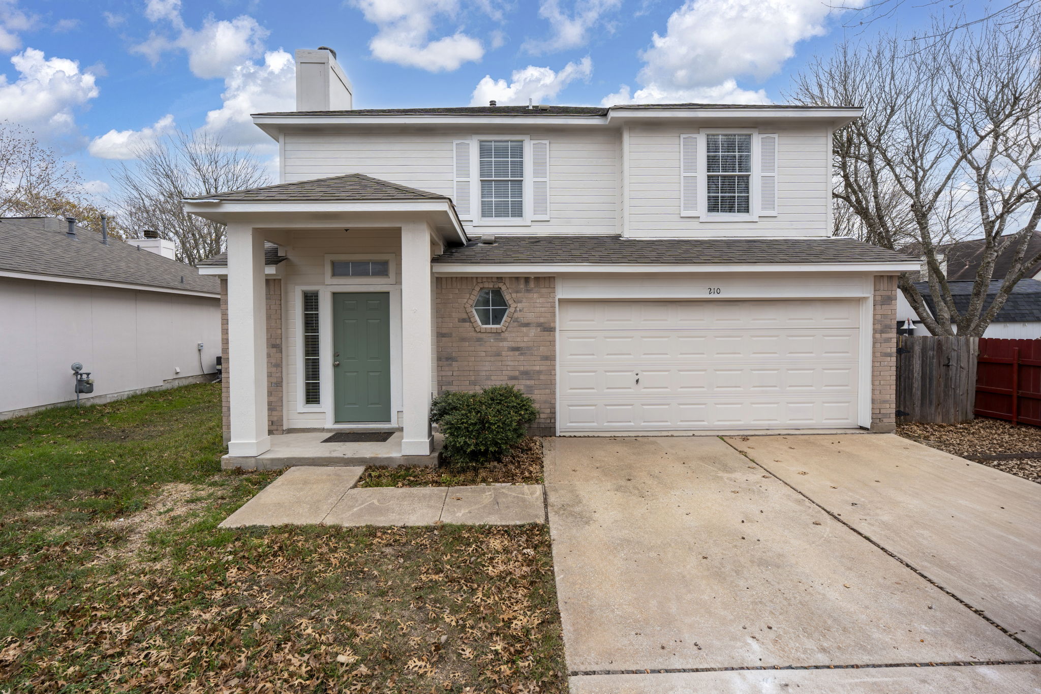 210 Summerside Avenue Lockhart, TX 78644 - Photo 1 of 1 a front view of a house with a yard and garage