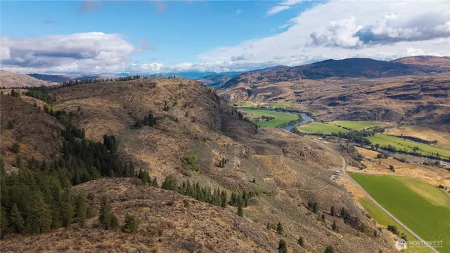 a view of a field with mountains in the background
