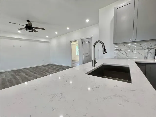 a kitchen with a sink cabinets and a stove
