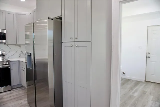 a bathroom with a shower and a glass door