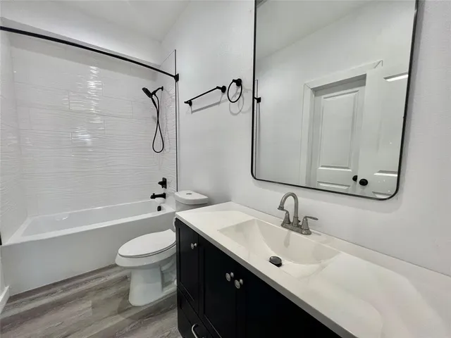a bathroom with a sink toilet tub and shower