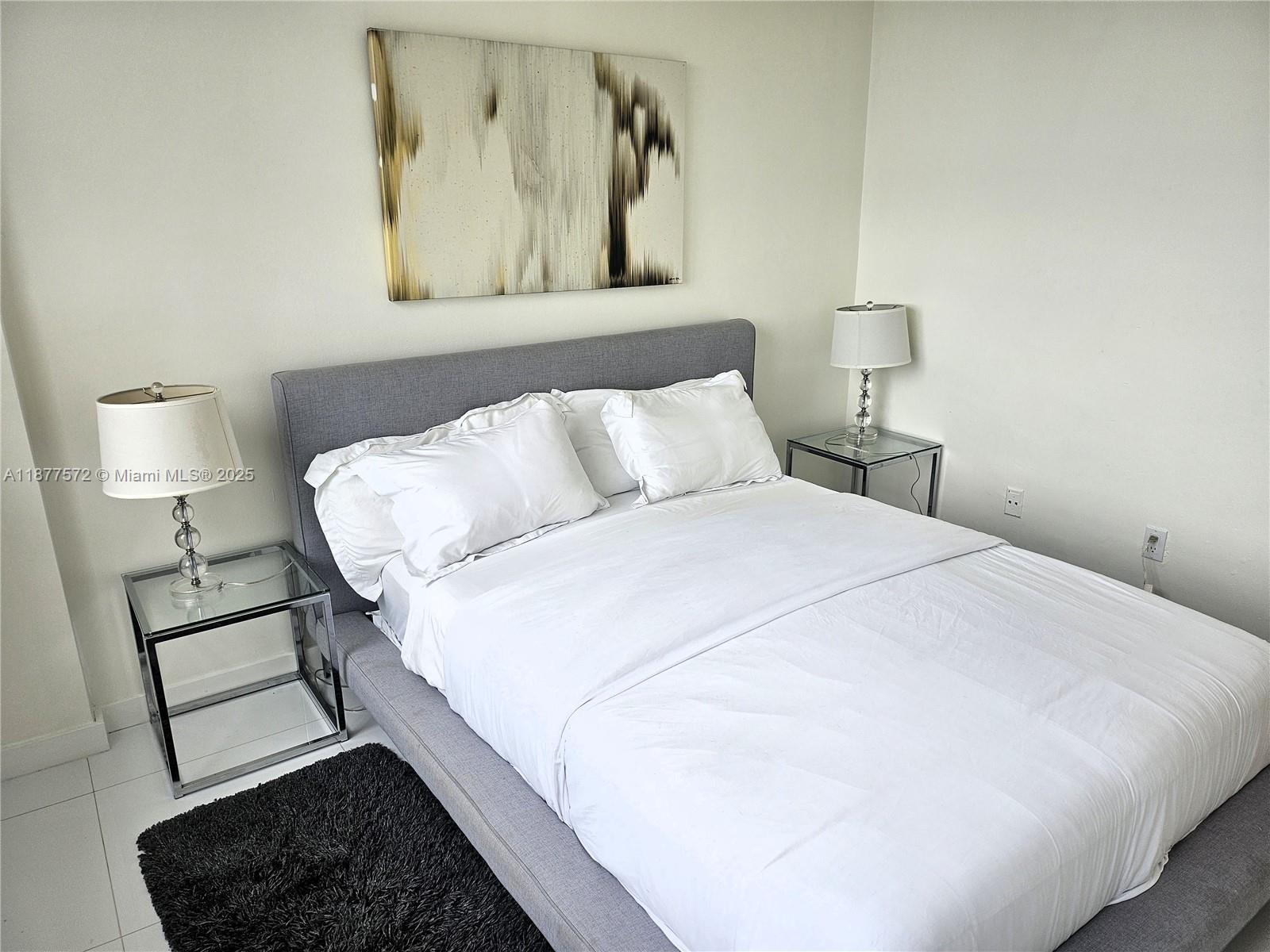 5161 Collins Avenue, Unit 707 Miami Beach, FL 33140 - Photo 13 of 69 a bedroom with a bed and a night stand