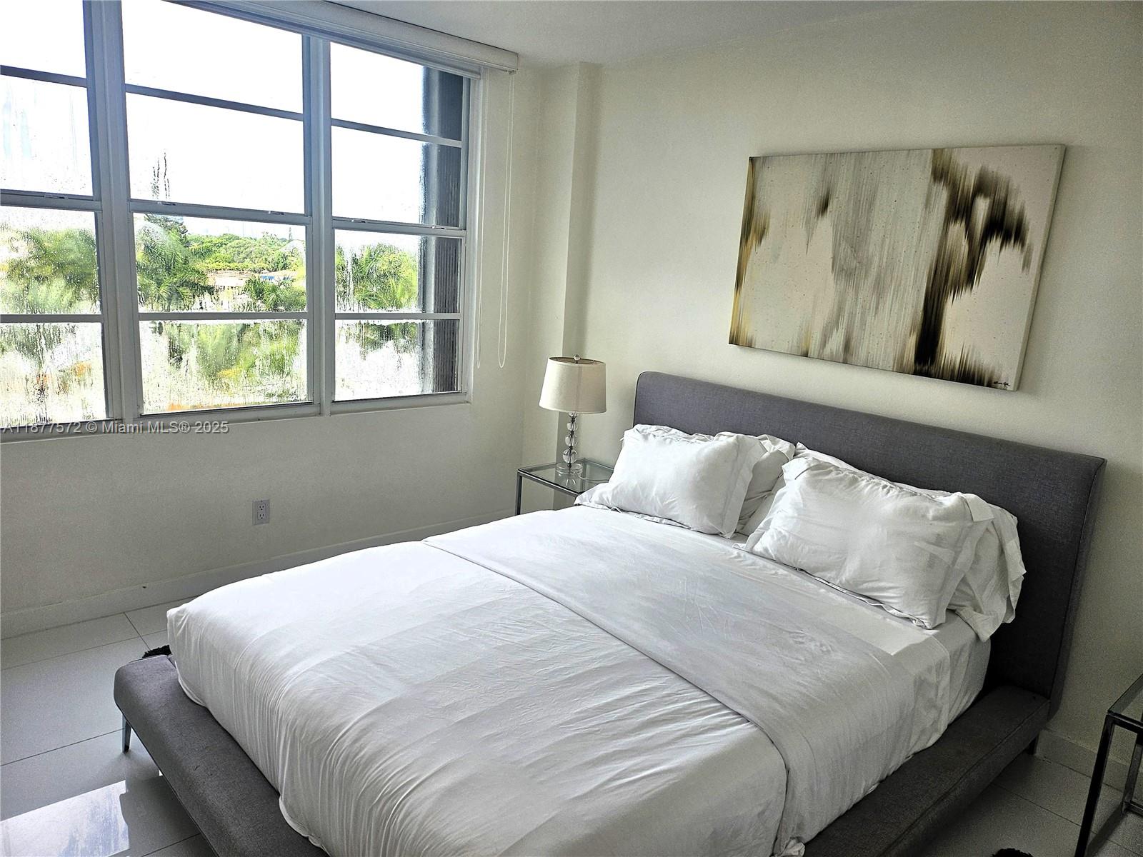 5161 Collins Avenue, Unit 707 Miami Beach, FL 33140 - Photo 16 of 69 a bedroom with a bed and a window