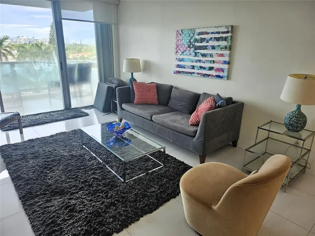 a living room with furniture rug and window