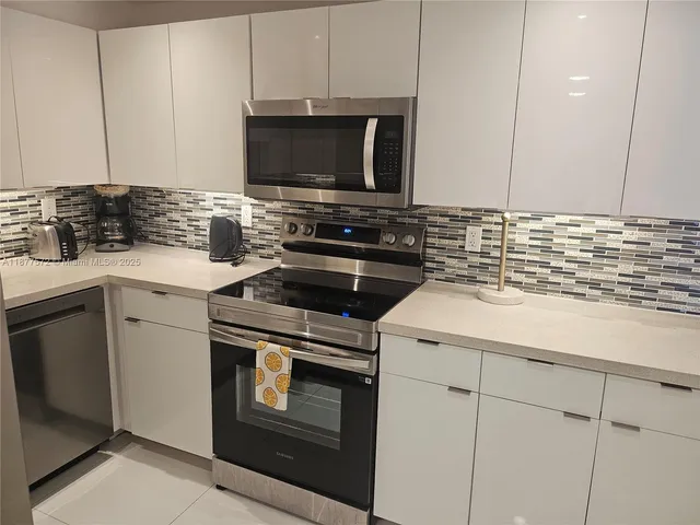 a kitchen with a sink stove and cabinets